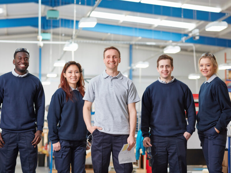 Portrait manager and team in manufacturing factory - showing the kind of people who will receive and benefit from good internal communications, such as a company newsletter
